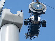 Components of a horizontal axis wind turbine (gearbox, rotor shaft and brake assembly) being lifted into position